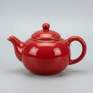 Reference 1: a glossy red ceramic teapot on a plain grey background