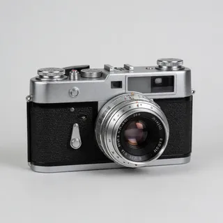 Reference 4: a vintage silver film camera on a plain grey background